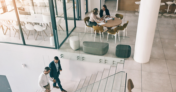 People walking and sitting in an office setting