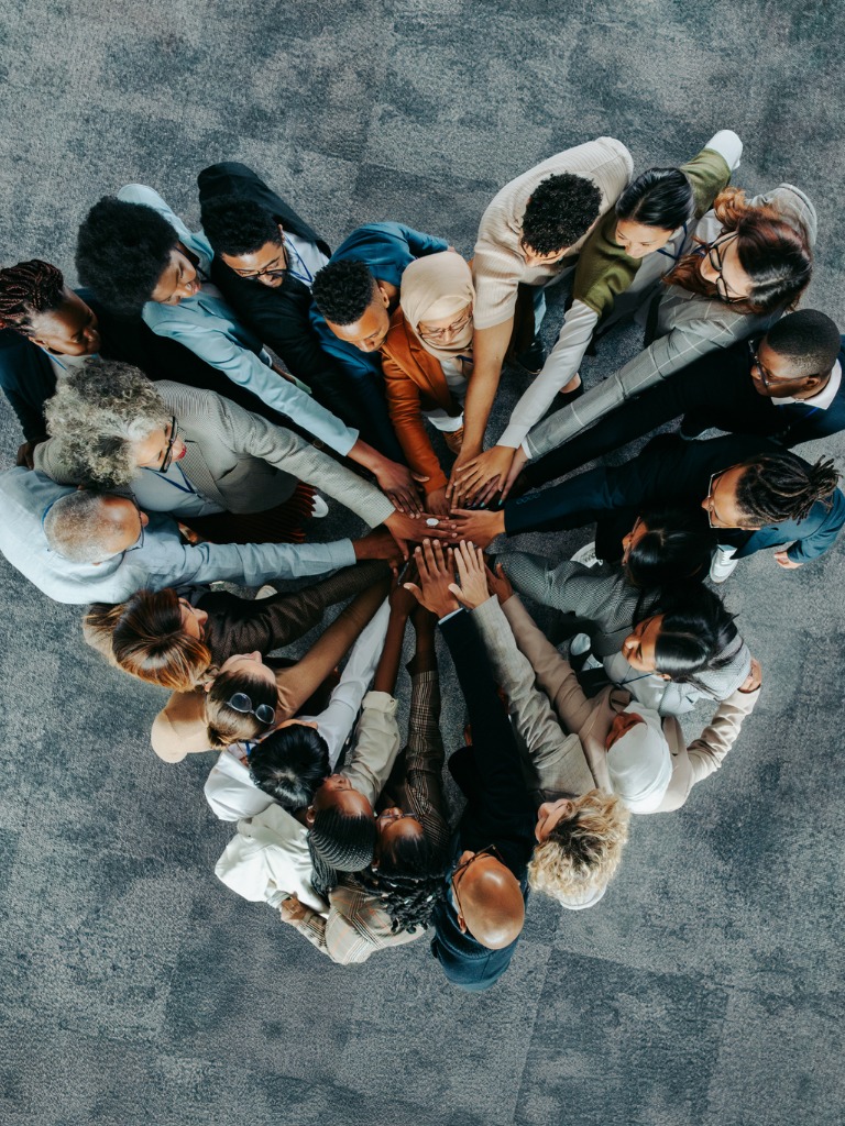 Group of diverse workers in a heart shaped symbol